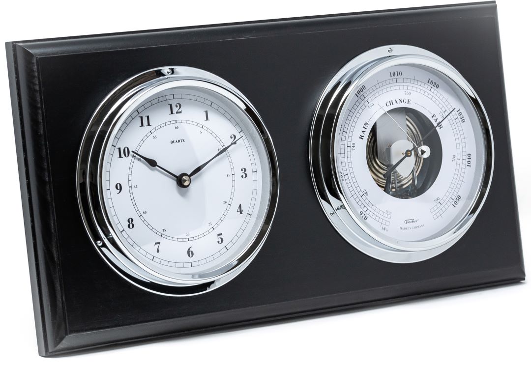 Black panel with chrome-rimmed barometer and clock, weather station home decor.