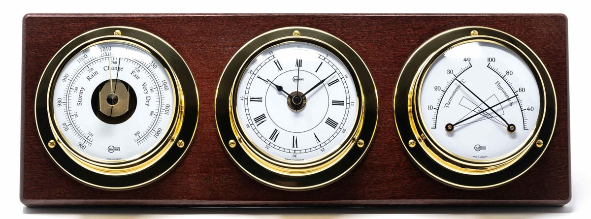 German made barometer, clock, and hygrometer with brass trim on wooden mount, nautical style.
