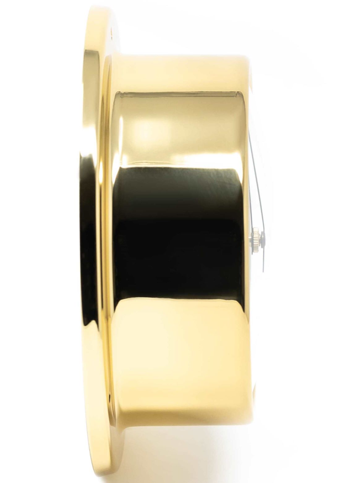 Side view of a polished brass barometer or nautical wall clock with glass face