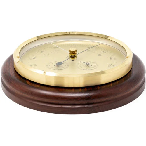German made barometer with brass bezel, mounted on round wood base, weather instrument