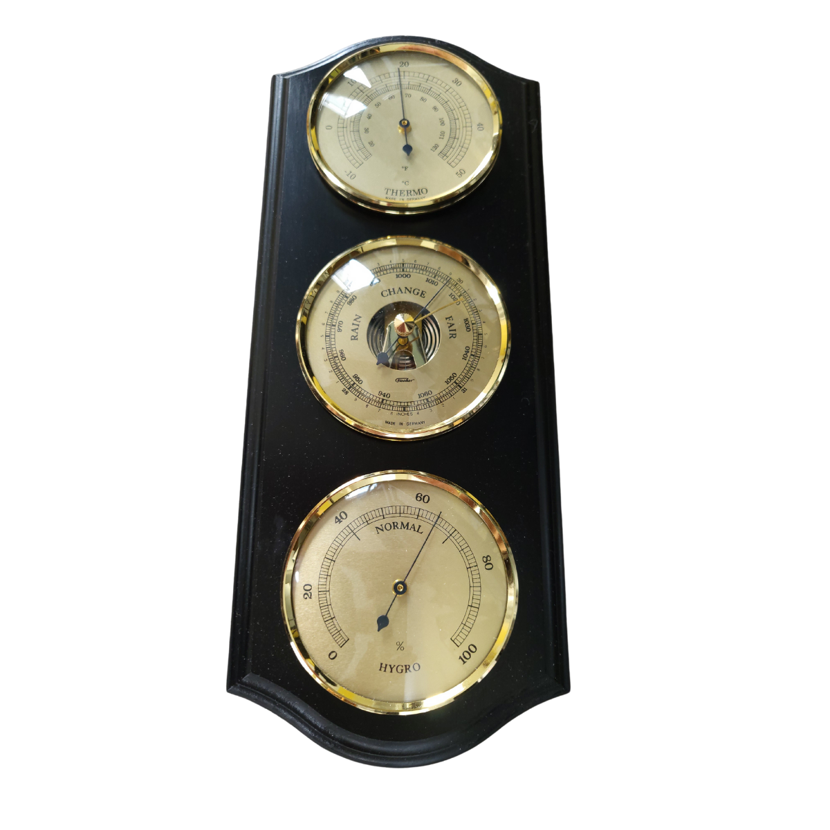 Wall-mounted weather station with brass barometer, thermometer, and hygrometer on black wood panel