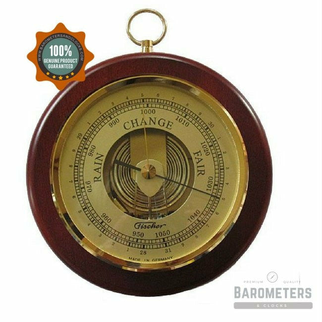 Classic round analog barometer with gold dial and wooden frame displaying weather readings